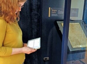 Emily Naish, Archivist at Salisbury Cathedral accessing temperature and humidity data from the HOBO MX1101 logger sealed inside the Magna Carta display cabinet.
